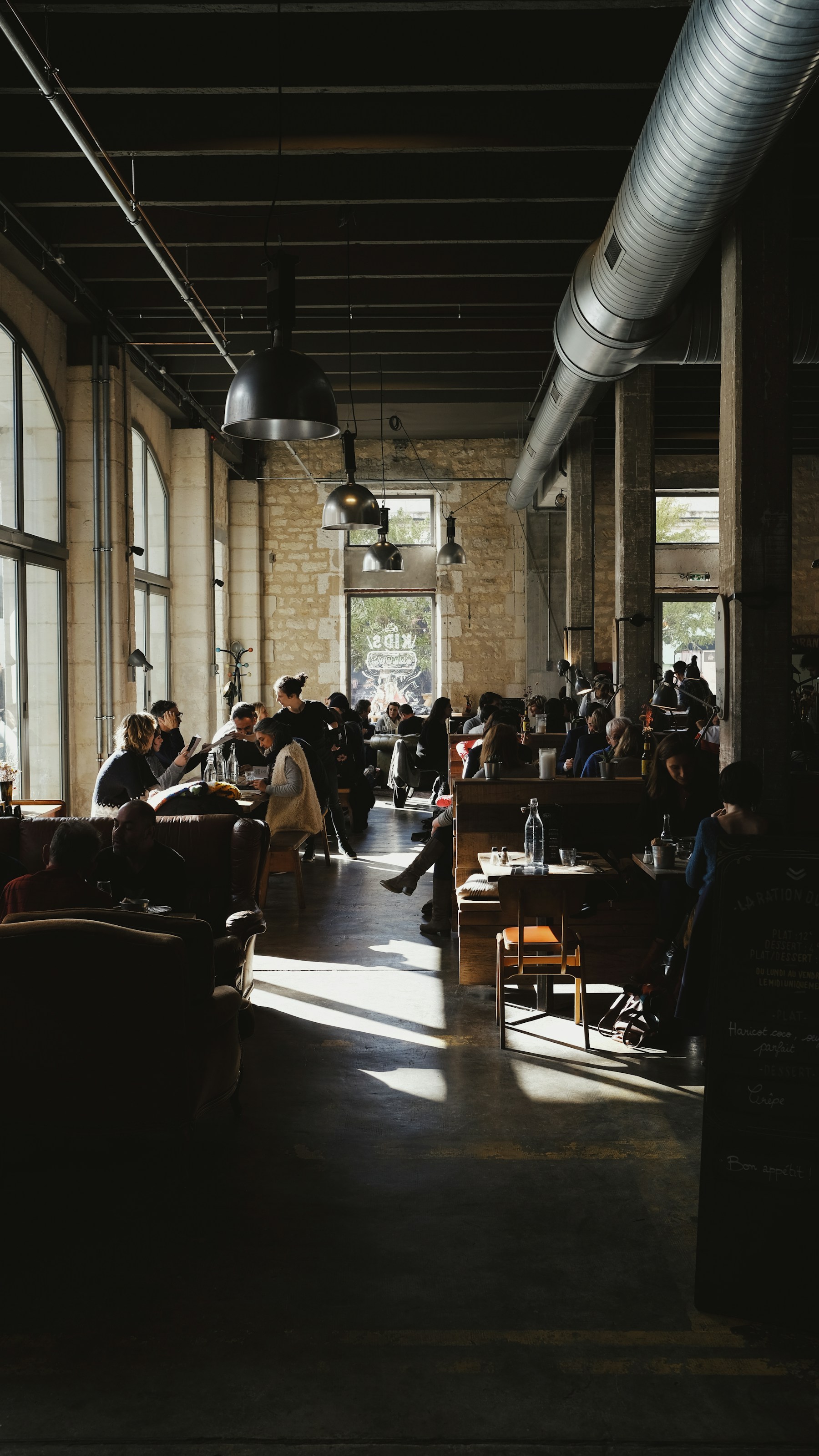 Group of people gathered inside a cafeteria-style room